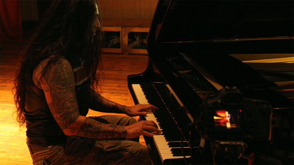 At the grand piano